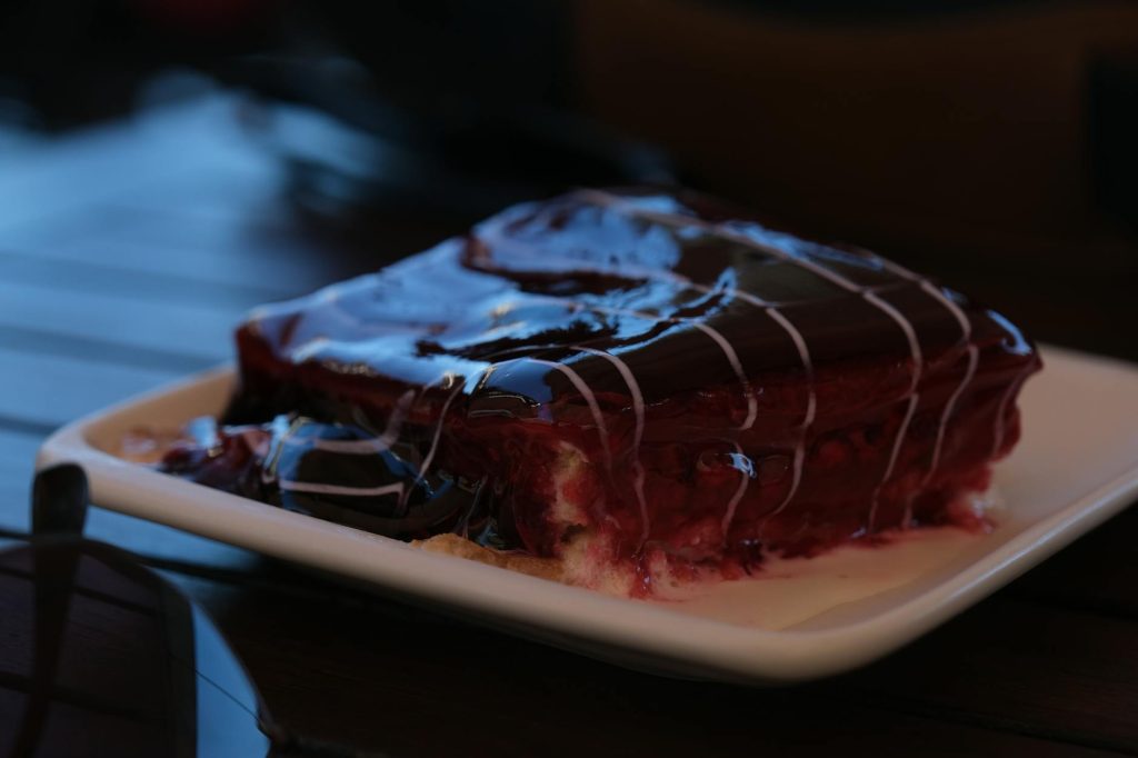 Baking Tips: Effortless Chocolate Perfection Close-up of a rich chocolate and raspberry dessert on a white plate.