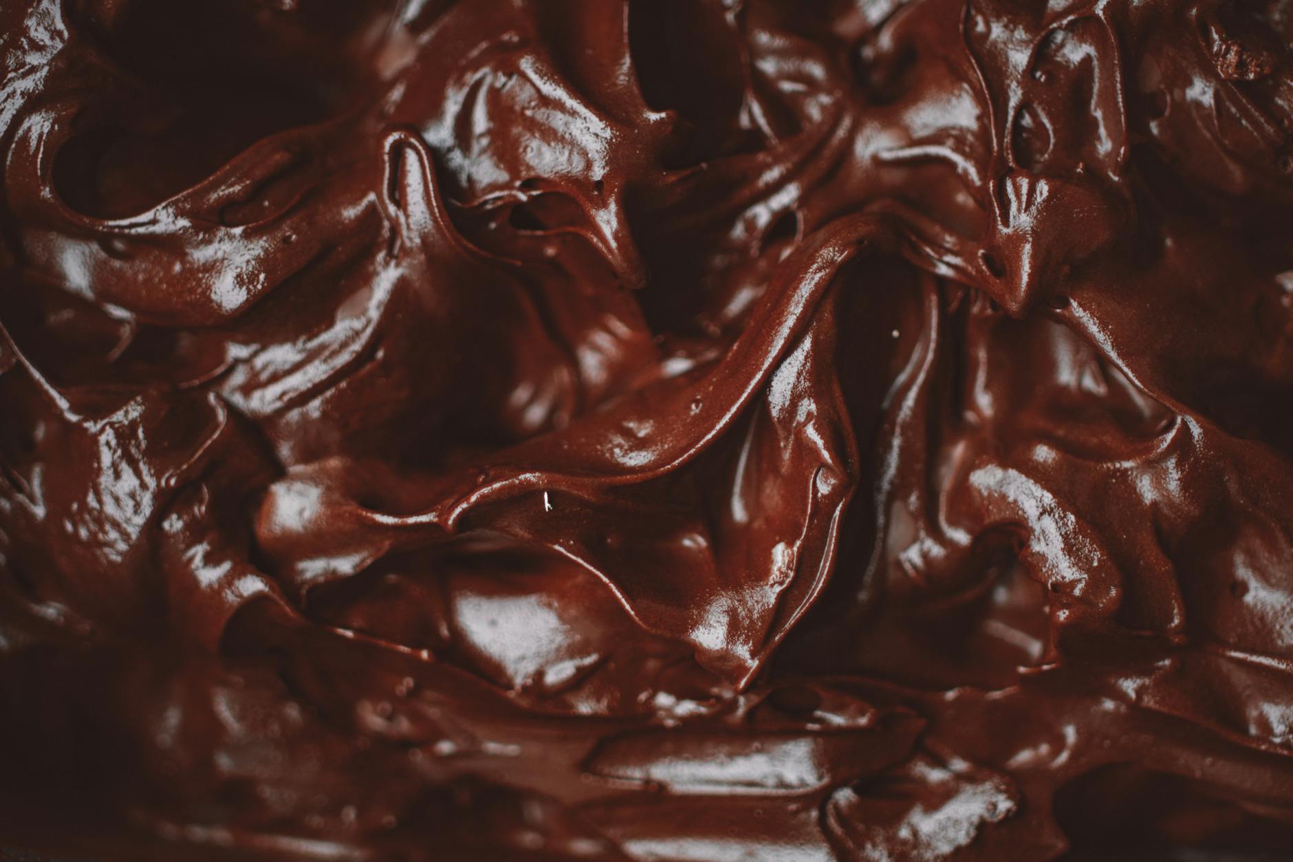 Vegan Chocolate Ganache Recipe: Indulge in this Effortless Delight Close-up of a decadent and velvety chocolate ganache, showing its rich texture.