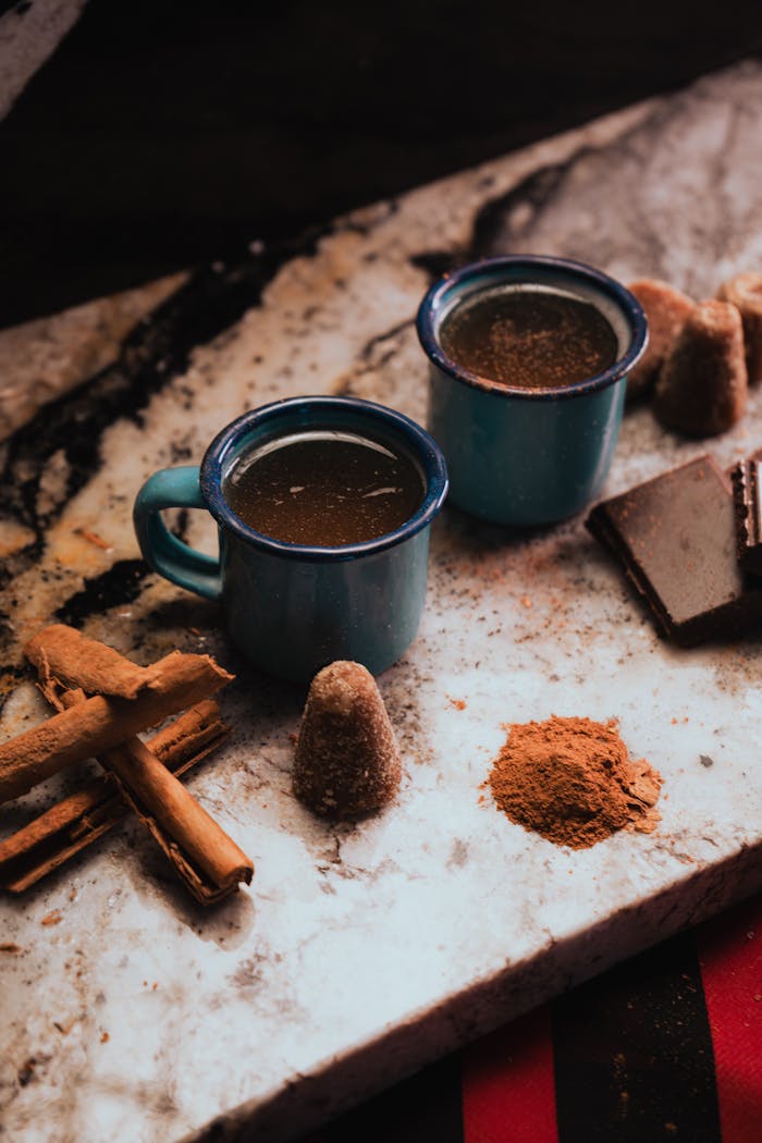 our-journey-03 Warm traditional Mexican hot chocolate with cinnamon served in blue mugs, perfect for cozy moments.