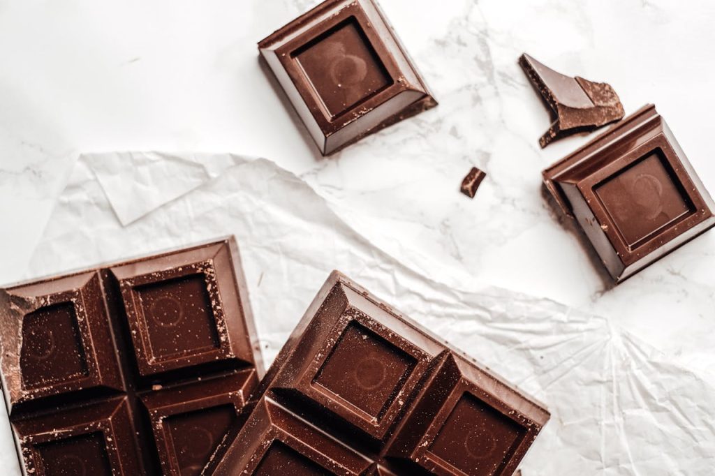 Delicious dark chocolate bars on a marble surface, captured in food photography style.